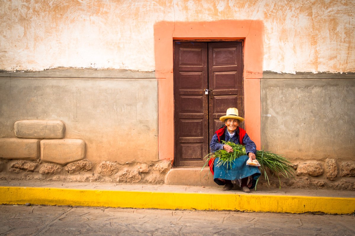 Peruvian woman sitting doorway