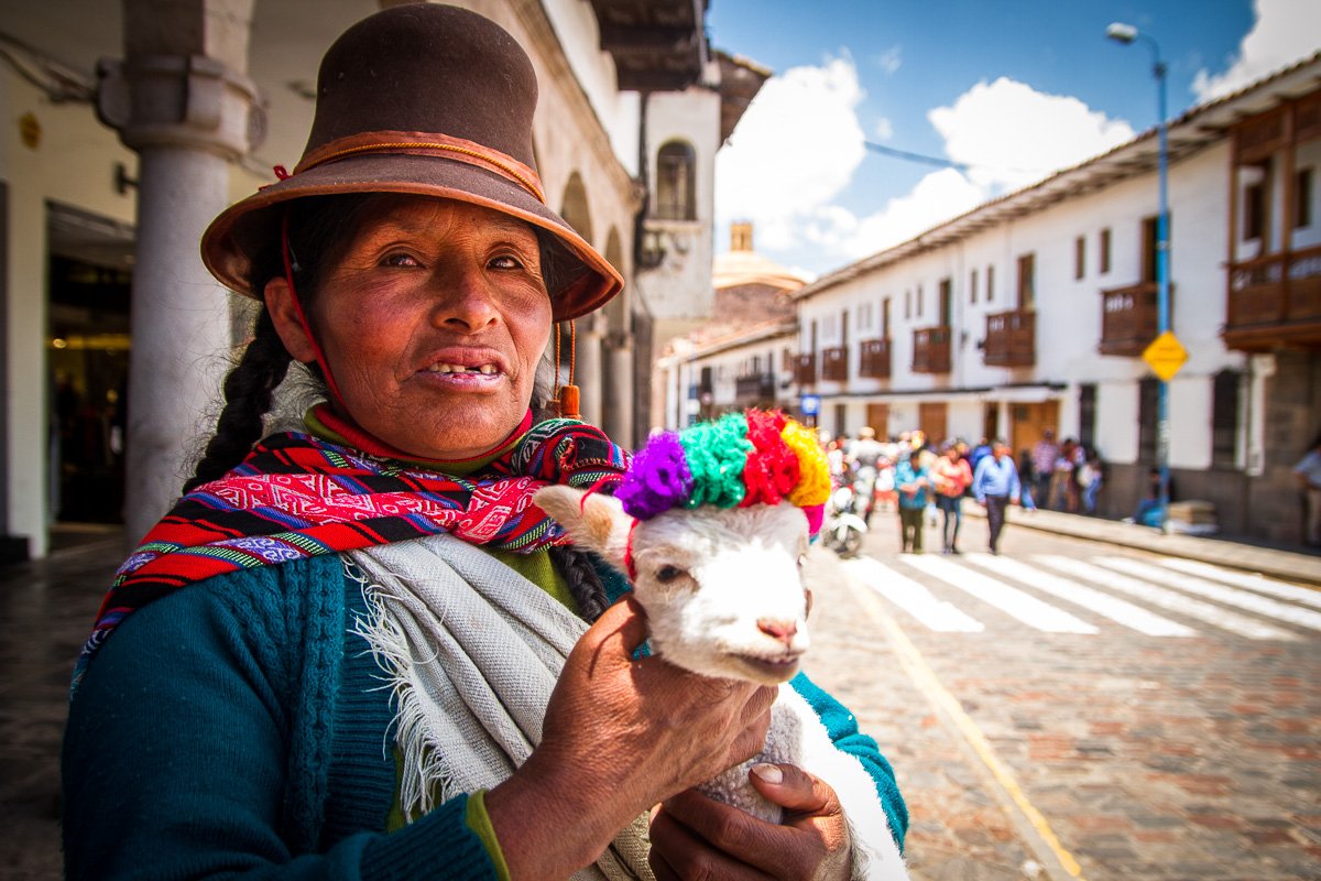 Peruvian woman with a baby sheep