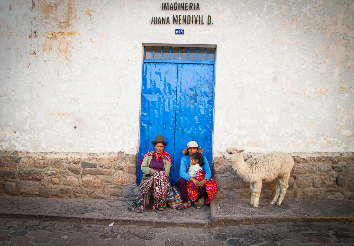 Family and a llama blue door