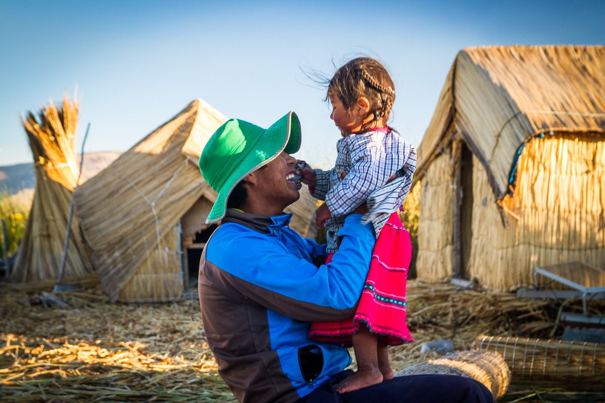 Los Uros floating islands man and baby